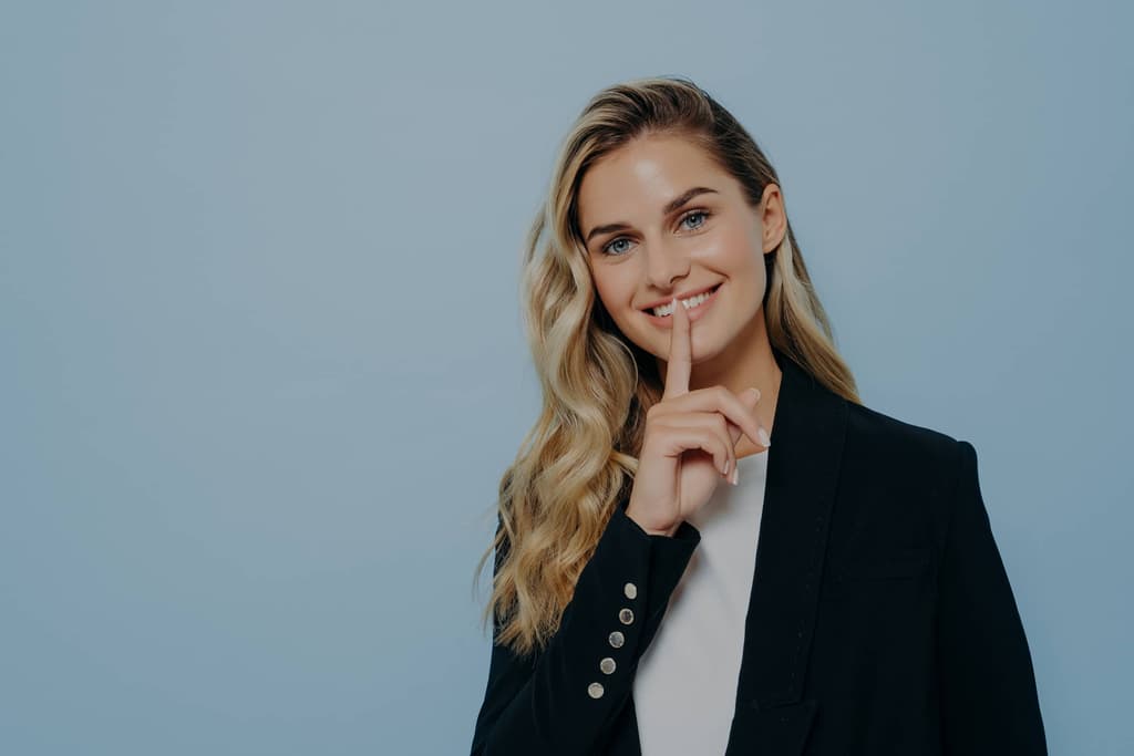 Woman smiling keeping good news as secret image